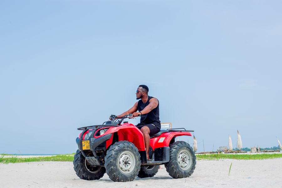 Person riding a quad bike on a beach