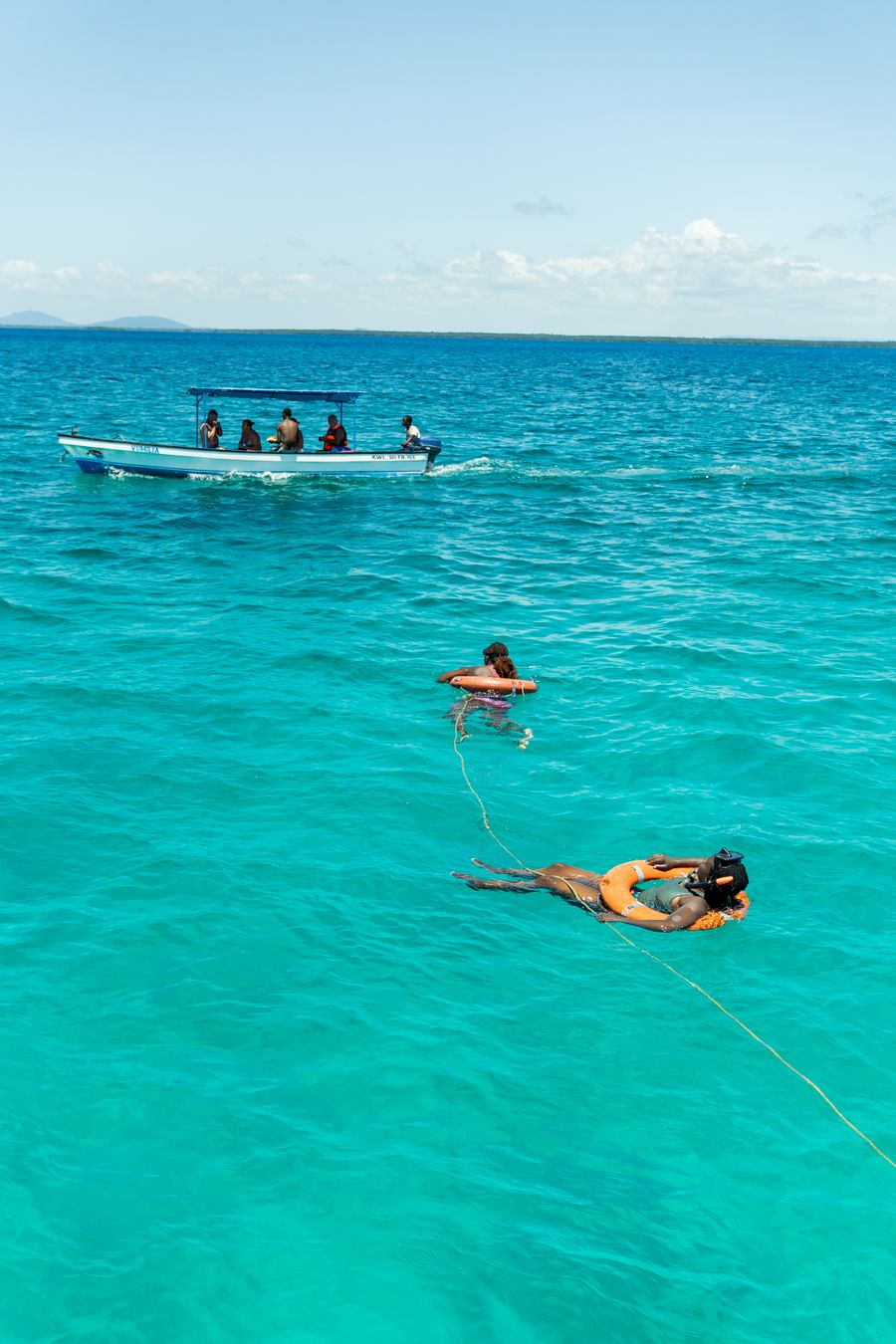 Snorkellers and boat in tropical waters